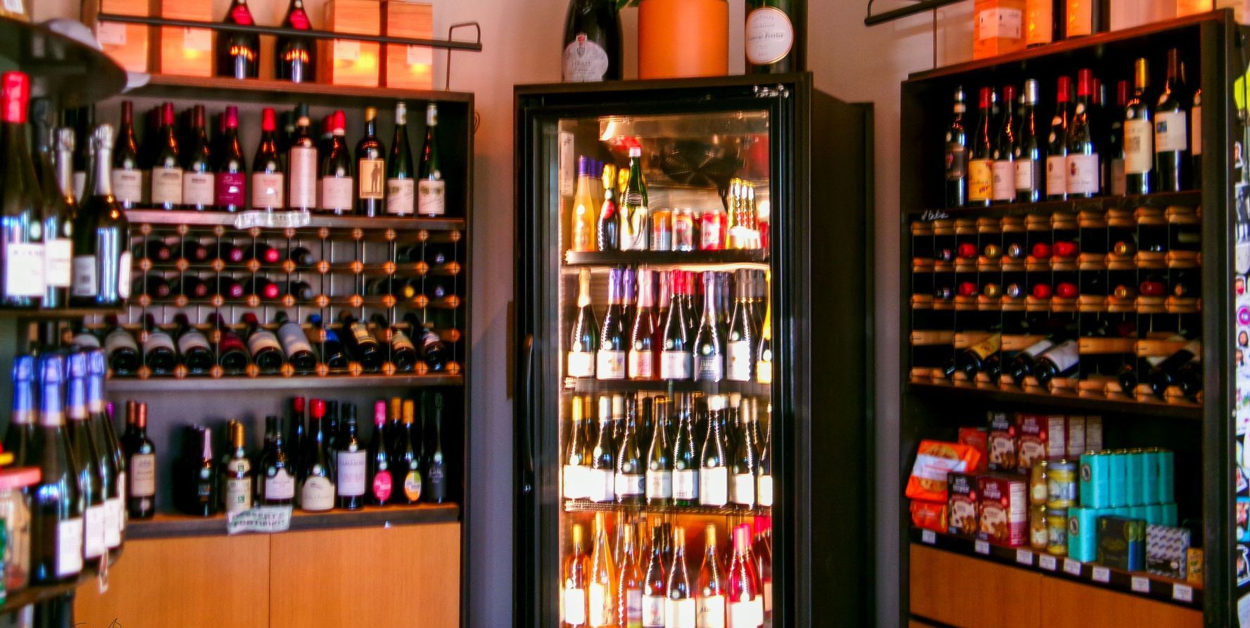 Vibrant wine shop interior showcasing assorted wine bottles on shelves.
